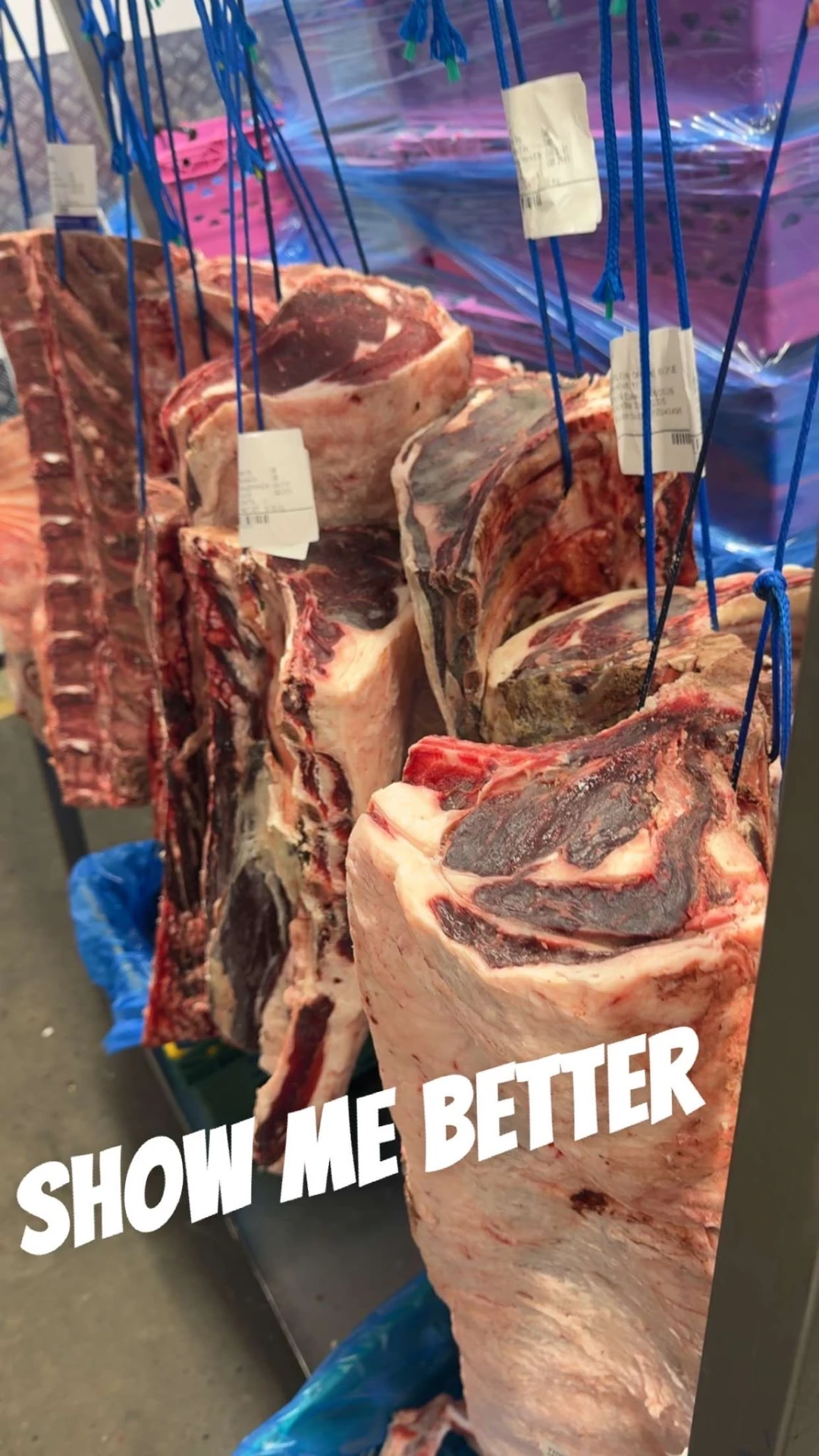 Beef hanging in the chiller under the butcher's care before being cut and prepared by hand