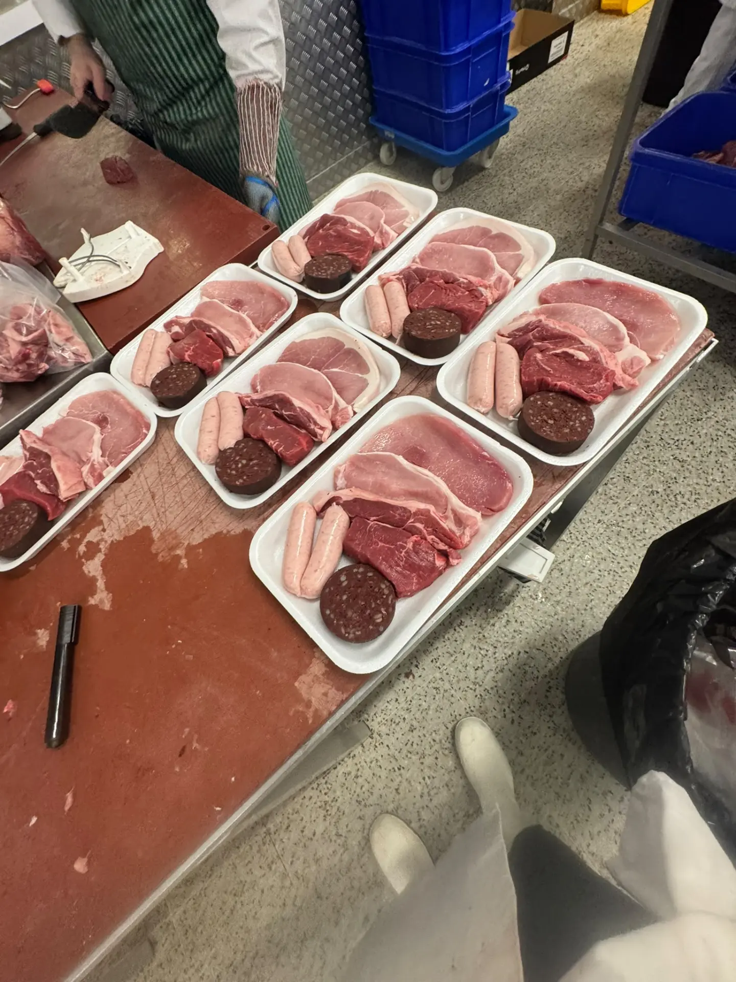 Anthony hand-preparing fresh breakfast packs on the butcher's block